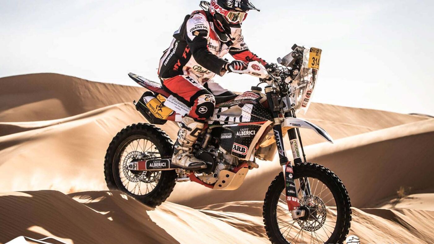 Rider testing Delpo-manufactured motorbike apparel across the dunes