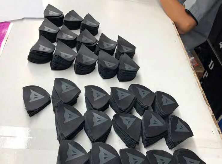 Finished Dainese logo badges ready for QC